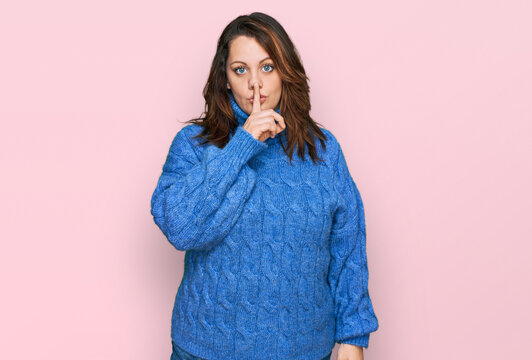 Young plus size woman wearing casual clothes asking to be quiet with finger on lips. silence and secret concept.
