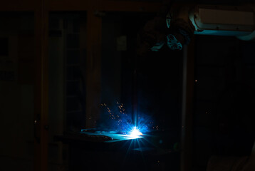 Obraz premium Technology background and texture for video. flare light effect of metal welding or blacksmith works at lathe industrial manufacturing factory