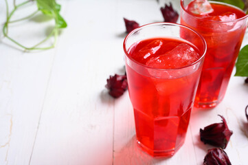 Roselle juice on wooden background, herbal organic tea for good healthy