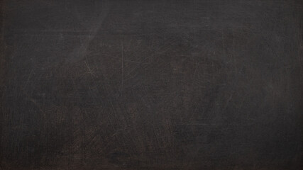 黒板、もしくはスクラッチのある黒い壁の背景テクスチャー
