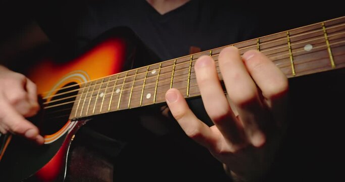 Playing on the guitar closeup footage