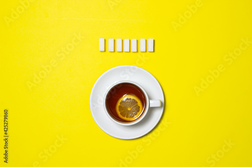 A Cup Of Tea With Lemon On A Yellow Background Creative Photography Of Tea With Sugar Sugar Cubes Next To Tea Wall Mural Ruzanna A Cup Of Tea With Lemon On A Yellow Background Creative Photography Of Tea With Sugar Sugar Cubes Next To Tea Wall Mural Ruzanna