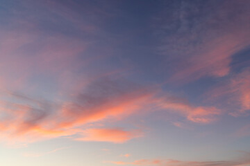 Orange clouds on blue sky at sunrise time.
