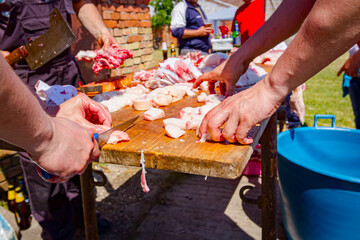 Butcher is cutting, processing fresh meat