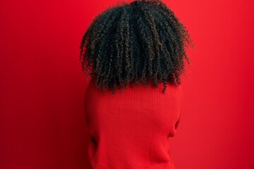 Beautiful african american woman with afro hair wearing sweater and glasses standing backwards looking away with crossed arms