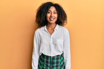 Beautiful african american woman with afro hair wearing scholar skirt with a happy and cool smile on face. lucky person.