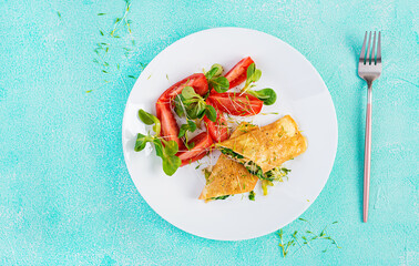 Omelette rolls on a plate. Homemade fried omelet rolls with chopped greens. Healthy low carb recipe. Top view, above