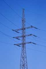 high-voltage tower with blue sky background.
