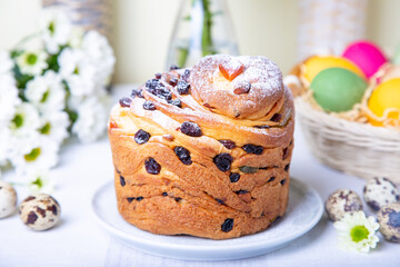 Craffin (Cruffin) with raisins and candied fruits. Easter Bread Kulich and painted eggs. Easter Holiday. Close-up.