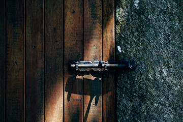part of closed wooden door with metal bolt