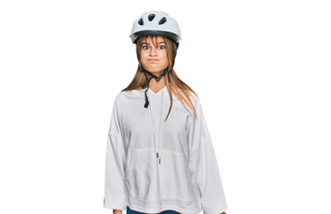 Teenager caucasian girl wearing bike helmet puffing cheeks with funny face. mouth inflated with air, crazy expression.