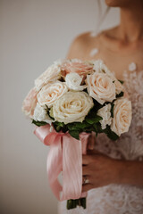 bride holding bouquet of roses