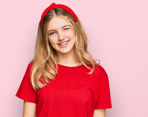 Beautiful young caucasian girl wearing casual red t shirt winking looking at the camera with sexy...