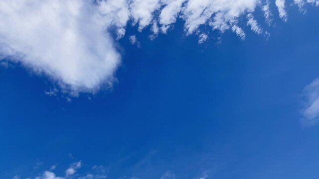 time-lapse footage of clouds in the sky drifting in the blue sky and eventually dissipate. Altocumulus cloud. Cloudscape. Japan.