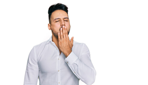 Young arab man wearing casual clothes bored yawning tired covering mouth with hand. restless and sleepiness.