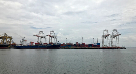 The port has a crane and a container. Concept of water transport