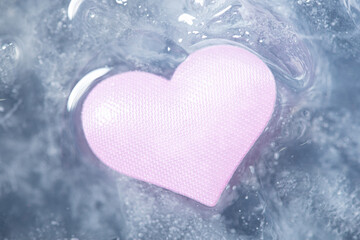 Obraz premium Pink heart melting from the ice. Start of love, relationsips