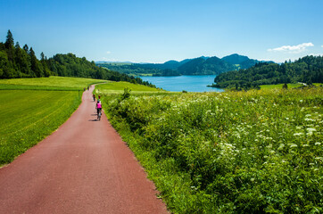 Cycling around Czorsztynskie lake near Niedzica village on sunny spring day, Pieniny Mountains, Poland