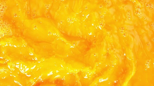 Super Slow Motion Shot of Swirling Fresh Orange Juice Background at 1000 fps.