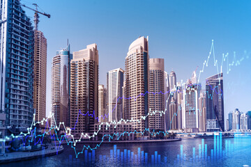 Skyscrapers of Dubai business downtown. International hub of trading and financial services of Western Asia. FOREX graph and chart concept. Double exposure. Dubai Canal waterfront.