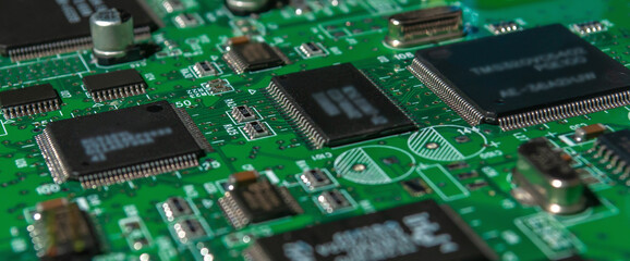 printed circuit board with surface mounted passive and active circuit components close up