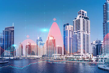 Fototapeta premium Skyscrapers of Dubai business downtown. International hub of trading and financial services of Western Asia. FOREX graph and chart concept. Double exposure. Dubai Canal waterfront.