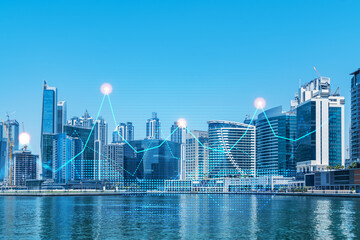 Skyscrapers of Dubai business downtown. International hub of trading and financial services of Western Asia. FOREX graph and chart concept. Double exposure. Dubai Canal waterfront.