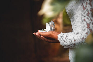 the bride holds a box with wedding rings