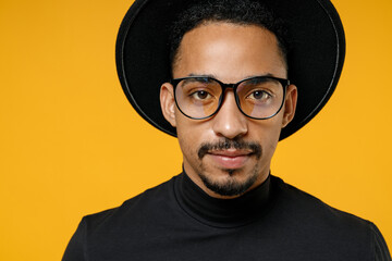 Close up of young attractive serious african american man 20s in stylish black hat shirt eyeglasses...