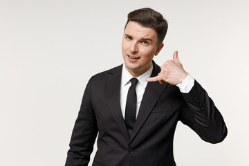 Young successful employee business corporate lawyer man in classic formal black grey suit shirt tie work in office do phone gesture like says call me back isolated on white background studio portrait.