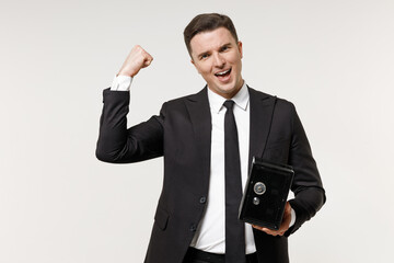 Young employee business corporate lawyer man 20s in classic black grey suit shirt tie work in office hold metal bank safe for money accumulation do winner gesture isolated on white background studio