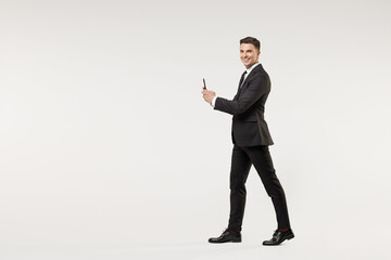 Side view full length of young employee business corporate lawyer man in classic formal black grey...