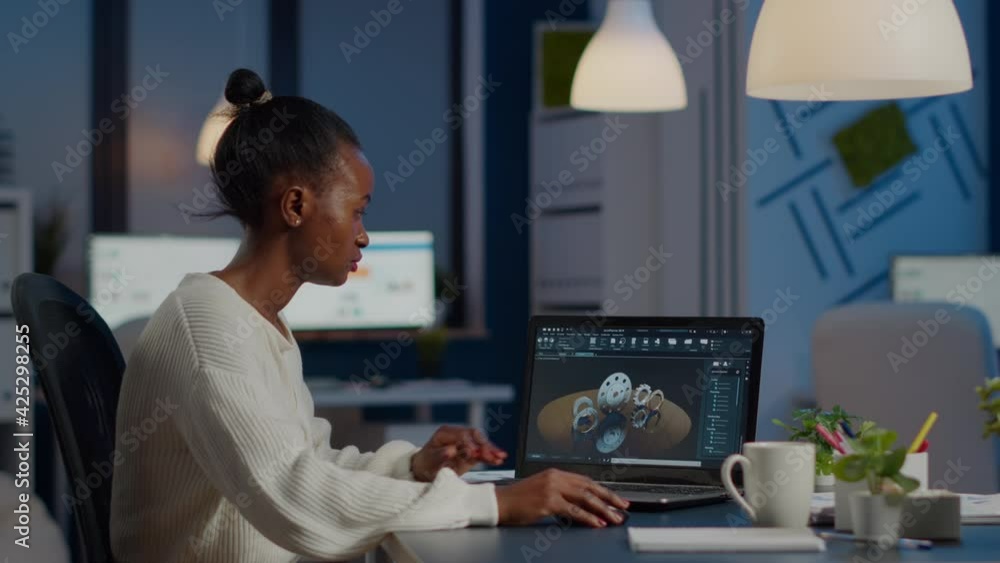 Aufkleber african woman engineer working in modern cad program with gear sitting at desk in start-up business 