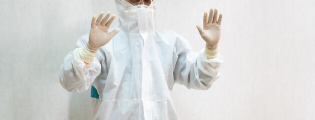 Portrait  Asian doctor in full protective equipment protective PPE suit wearing face mask and eyeglasses.