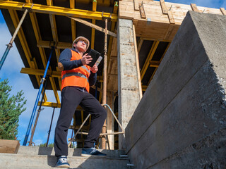Civil engineer at work. Man at a construction site. An employee of a engineer company inspects...