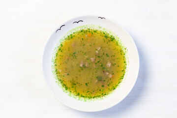 cream soup of vegetables, carrot, onion, potato, Brussels sprouts, dill, spices in bowl on white background