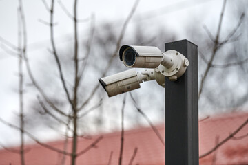 IP CCTV security camera on pole, urban cityscape