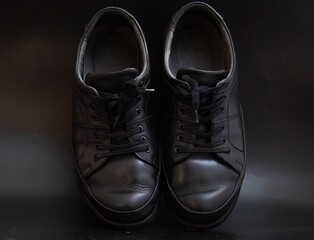Black men's shoes on a black background