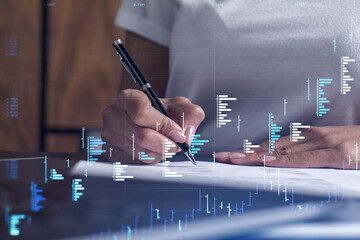 A client in casual wear is signing the contract to invest money in stock market. Internet trading...