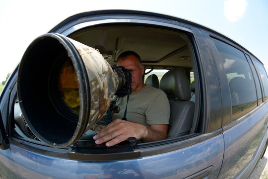 wildlife photographer sitting in the car