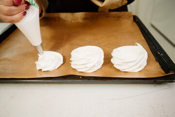Cake Anna Pavlova. The process of making a cake Anna Pavlova. The pastry chef decorates the cake Anna Pavlova. Making a cake Anna Pavlova.