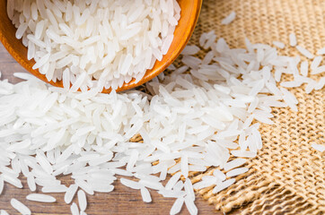 Organic Thai Jasmine rice grain in wooden bowl.