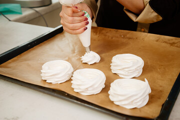 Cake Anna Pavlova. The process of making a cake Anna Pavlova. The pastry chef decorates the cake Anna Pavlova. Making a cake Anna Pavlova.