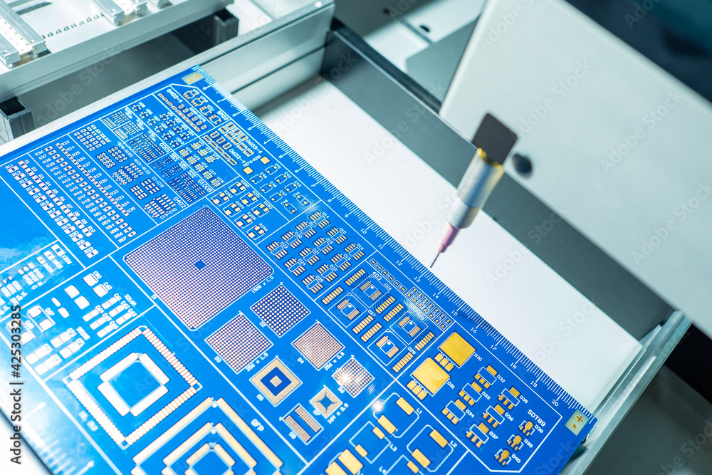 Poster automated production of printed circuit boards. blue pcb during production. pcb production machine. 