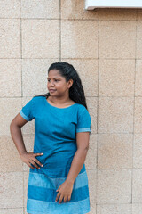 Side portrait of smiling young black woman standing outside