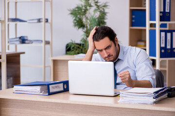 Young male bookkeeper working in the office