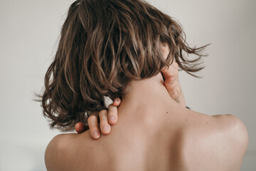 The girl massages her neck. Batch plan of the neck and arms. Professional body massage