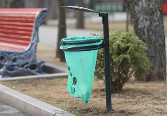 Urn with garbage in the park in the spring.