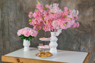 Side view on Flowers, candle and sweets on a Old Antique Wooden Drawer