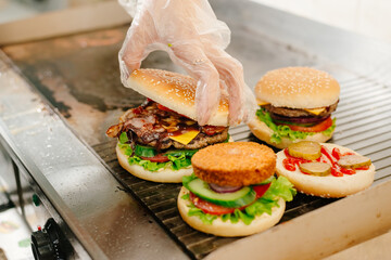 Burgers. The process of making burgers. The chef prepares burgers. Cooking burgers in the diner kitchen.